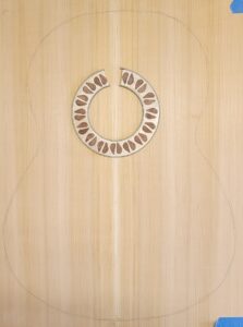 Rosette inlay glued into top.